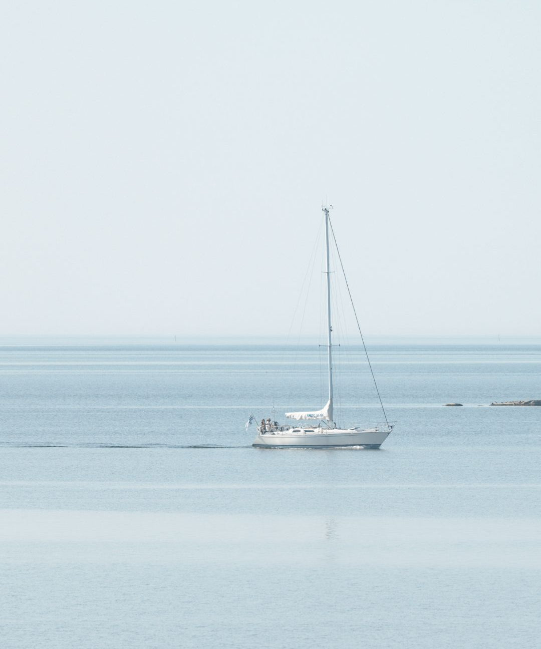 Sailboat on a calm sea in the Finnish archipelago, Saaren Taika sustainability report